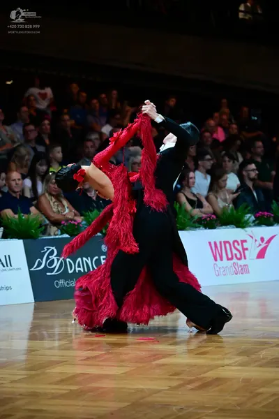 Dancesport competitor: Female dancer: red latin dress with long fringe