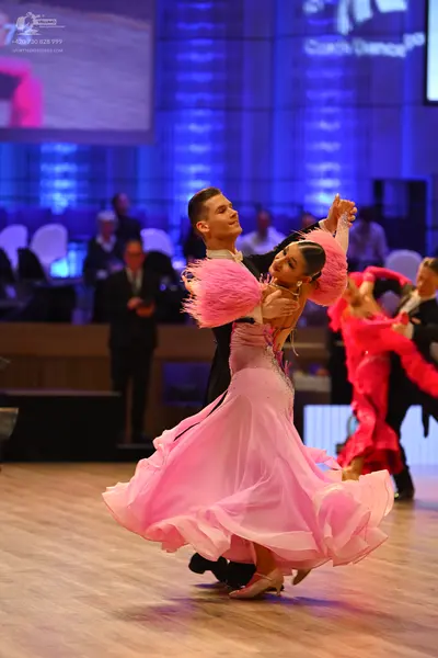 Dancesport competitor: Male dancer: black suit with a white shirt
