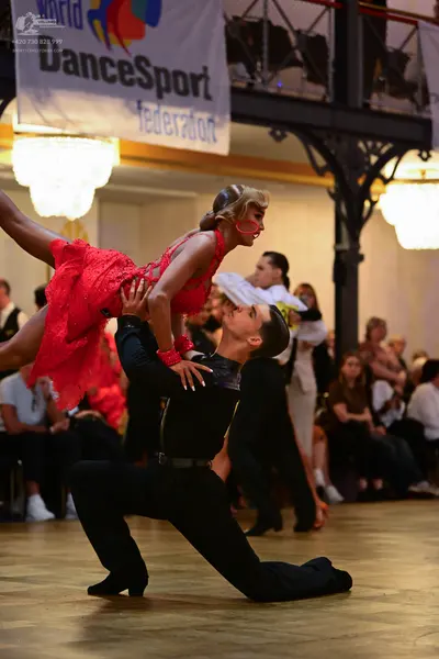 Dancesport competitor: Female dancer: red Latin dance dress with sequins