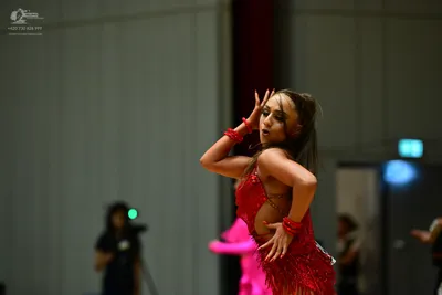 Dancesport competitor: Female dancer: red latin dress with sequins and fringe