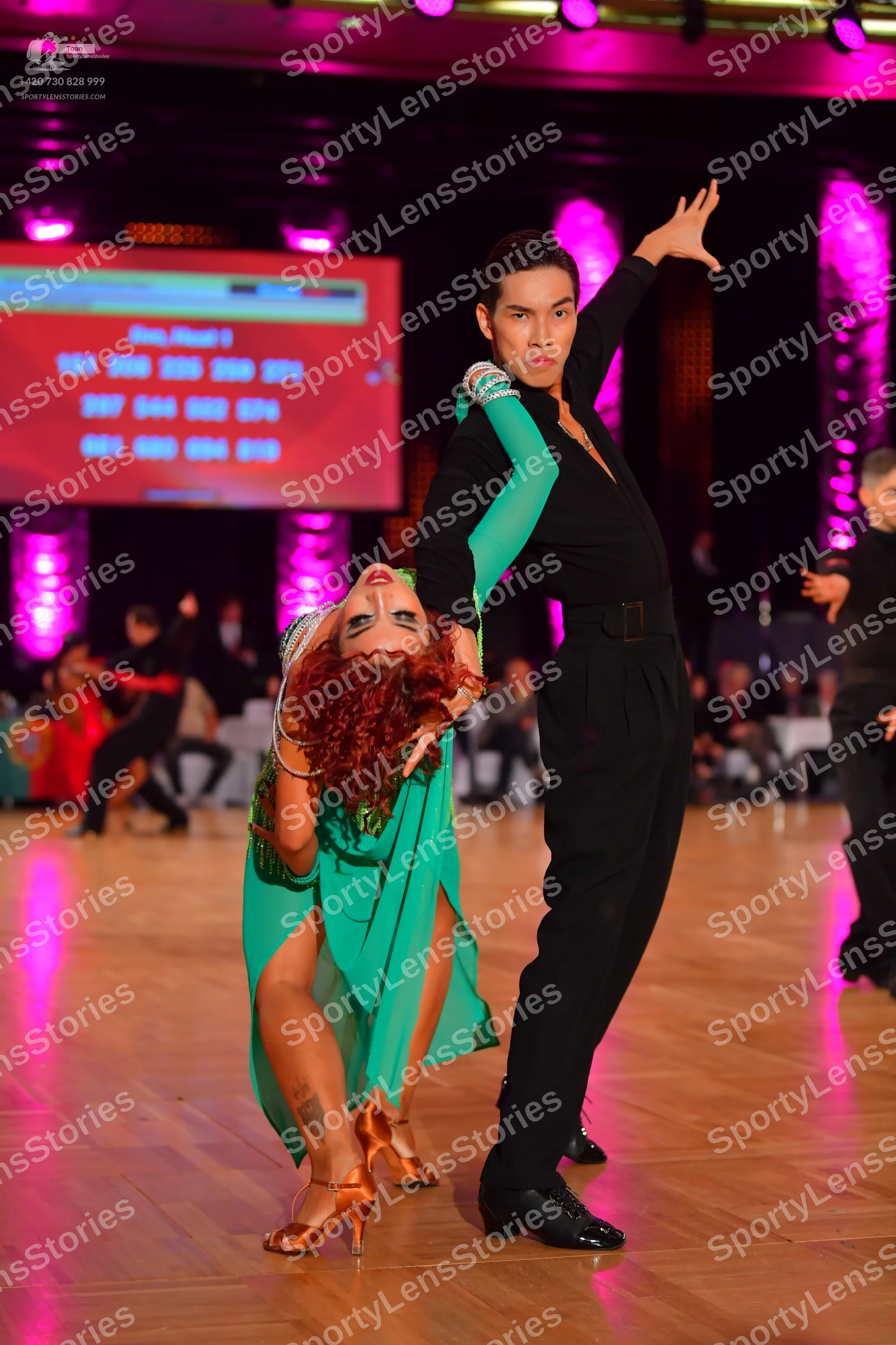 Dancesport competitor: Male dancer: black long-sleeved Latin dance top with silver/white embellishments