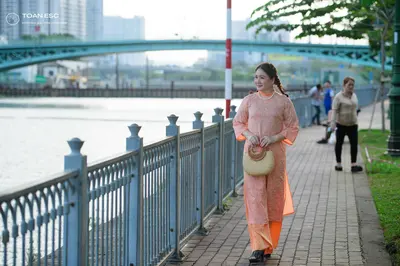 Dancesport competitor: Female dancer: peach-colored, semi-transparent, long-sleeved dress, likely made 
