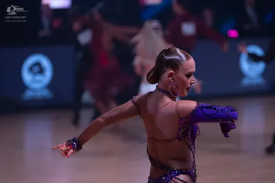 Dancesport competitor: Female dancer: purple Latin dance costume with heavy sequin/bead embellishments,