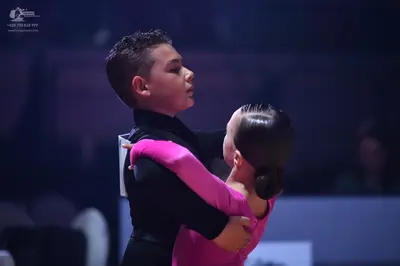 Dancesport competitor: Male dancer: black long-sleeved top