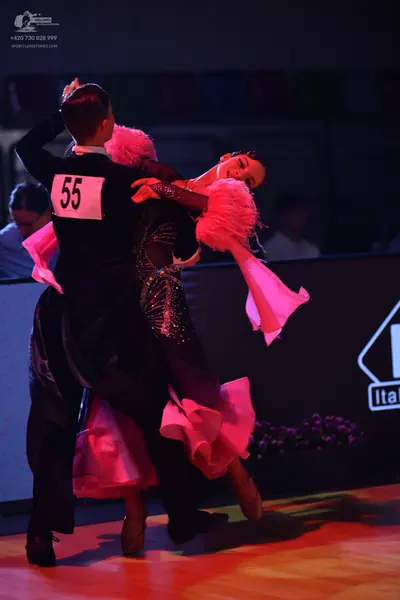 Dancesport competitor: Male dancer: black long-sleeved top and black trousers