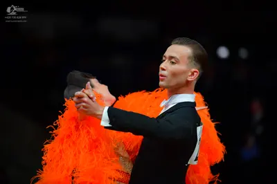 Dancesport competitor: Male dancer: black suit with a white shirt