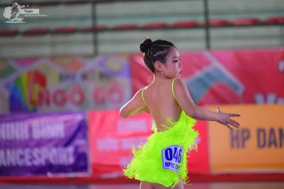 Dancesport competitor #048: ** Neon Yellow Latin Dress
*   **Color:** Bright Neon Yellow
*   **Fabric:** Shi