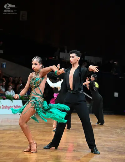 Dancesport competitor: Male dancer: black long-sleeved shirt with a deep V-neck and black trousers