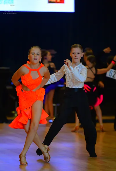 Dancesport competitor #62: Female dancer: orange latin dress with ruffles and cutouts