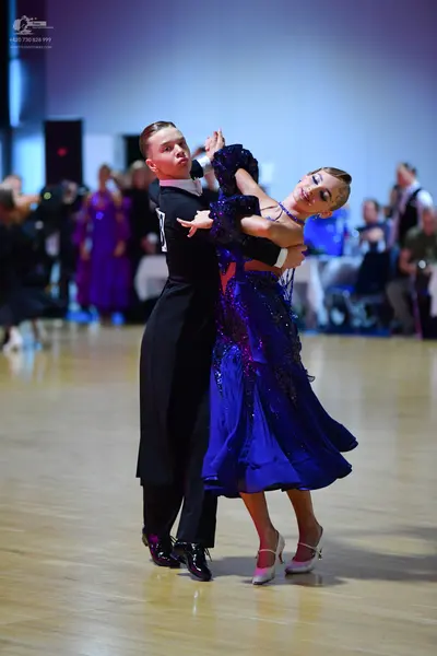Dancesport competitor: Male dancer: black long-sleeved top and black trousers