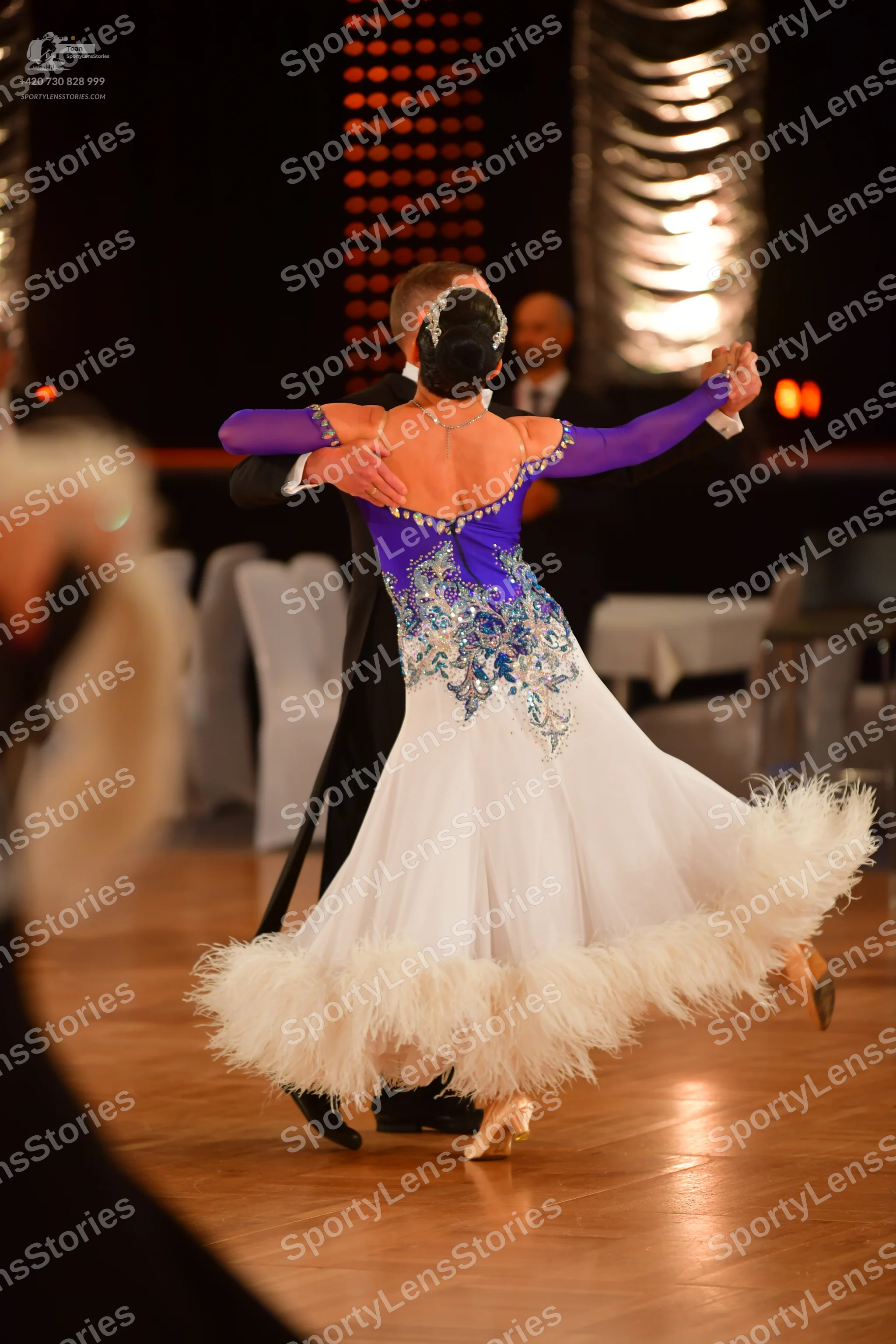 Dancesport competitor: Female dancer: purple long-sleeved bodice with silver/blue sequin embellishments