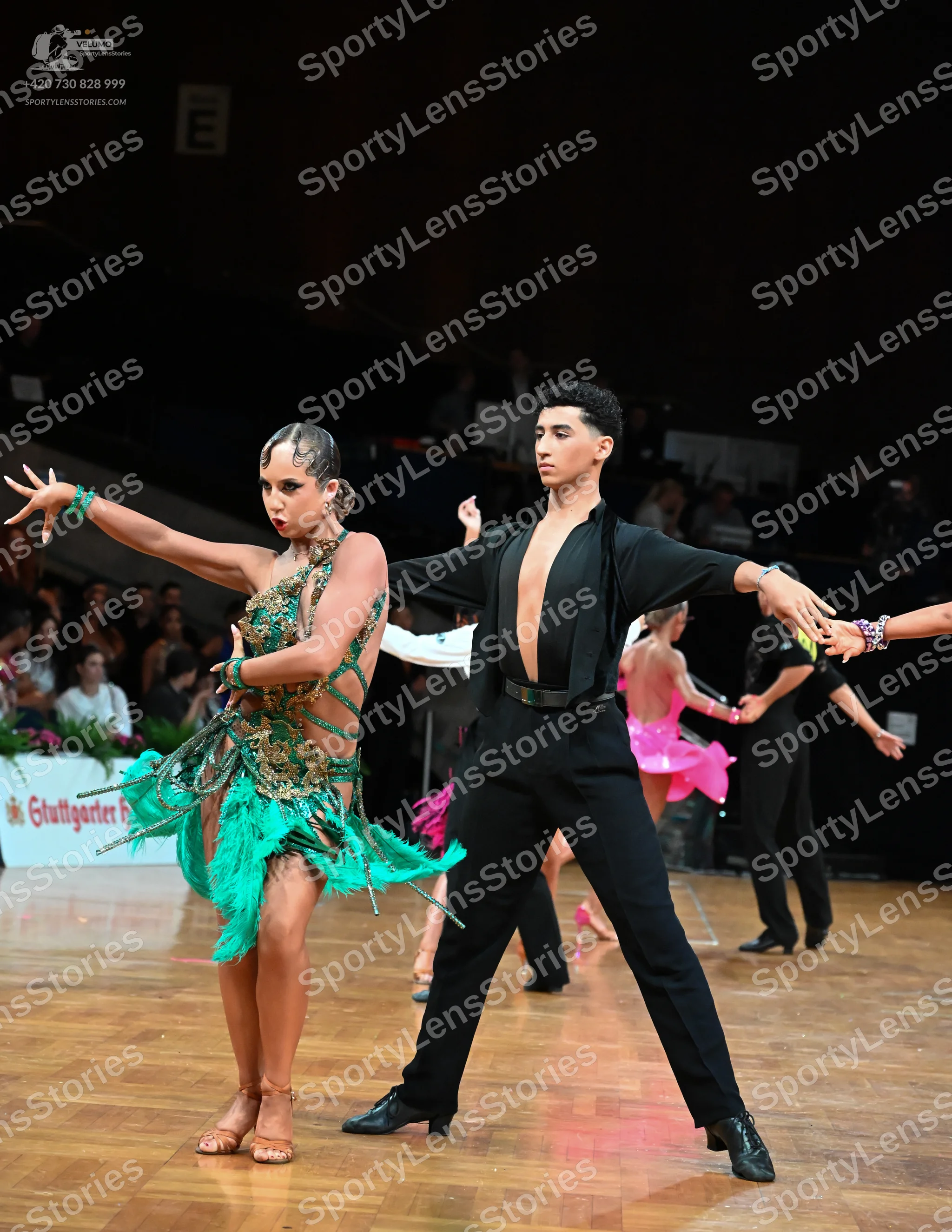 Dancesport competitor: Female dancer: green latin dress with fringe and sequins