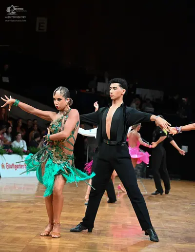 Dancesport competitor: Female dancer: green latin dress with fringe and sequins