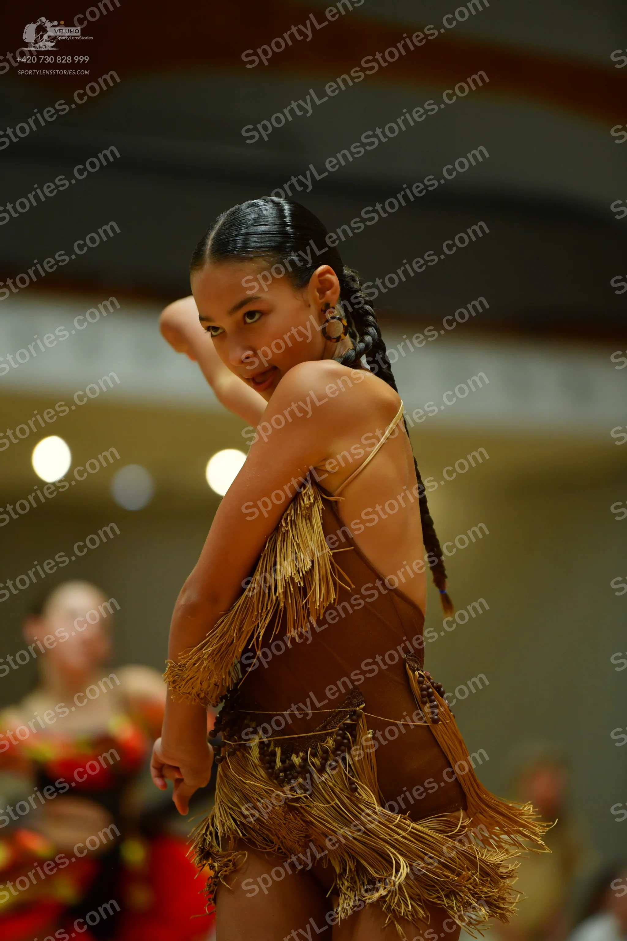 Dancesport competitor: Main dancer: brown Latin dance costume with long fringe and thin straps
