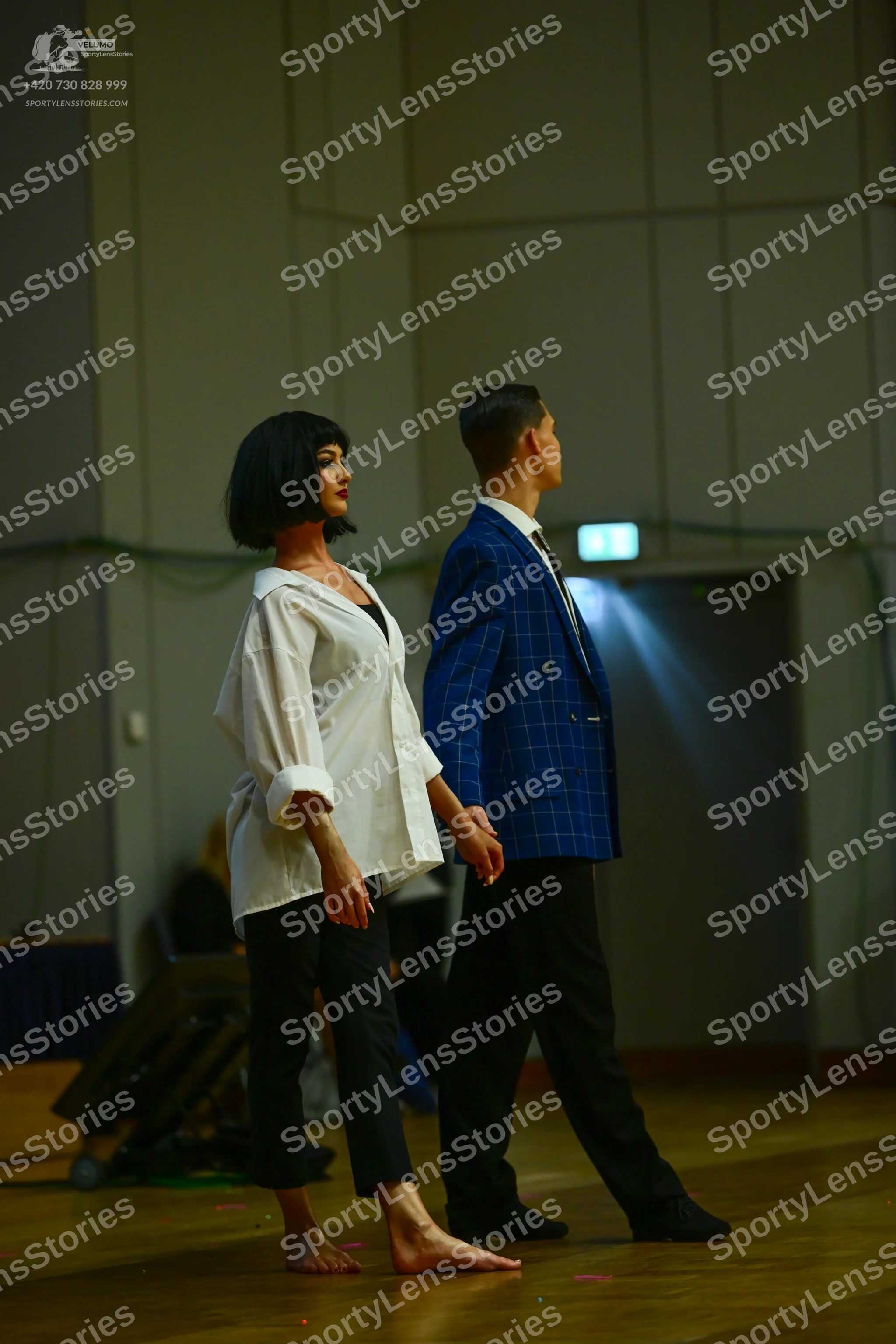 Dancesport competitor: Female dancer: white long-sleeved shirt and black trousers
