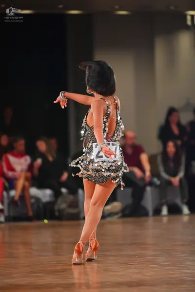 Dancesport competitor #26: Female dancer: dark latin dress covered in large silver sequins
