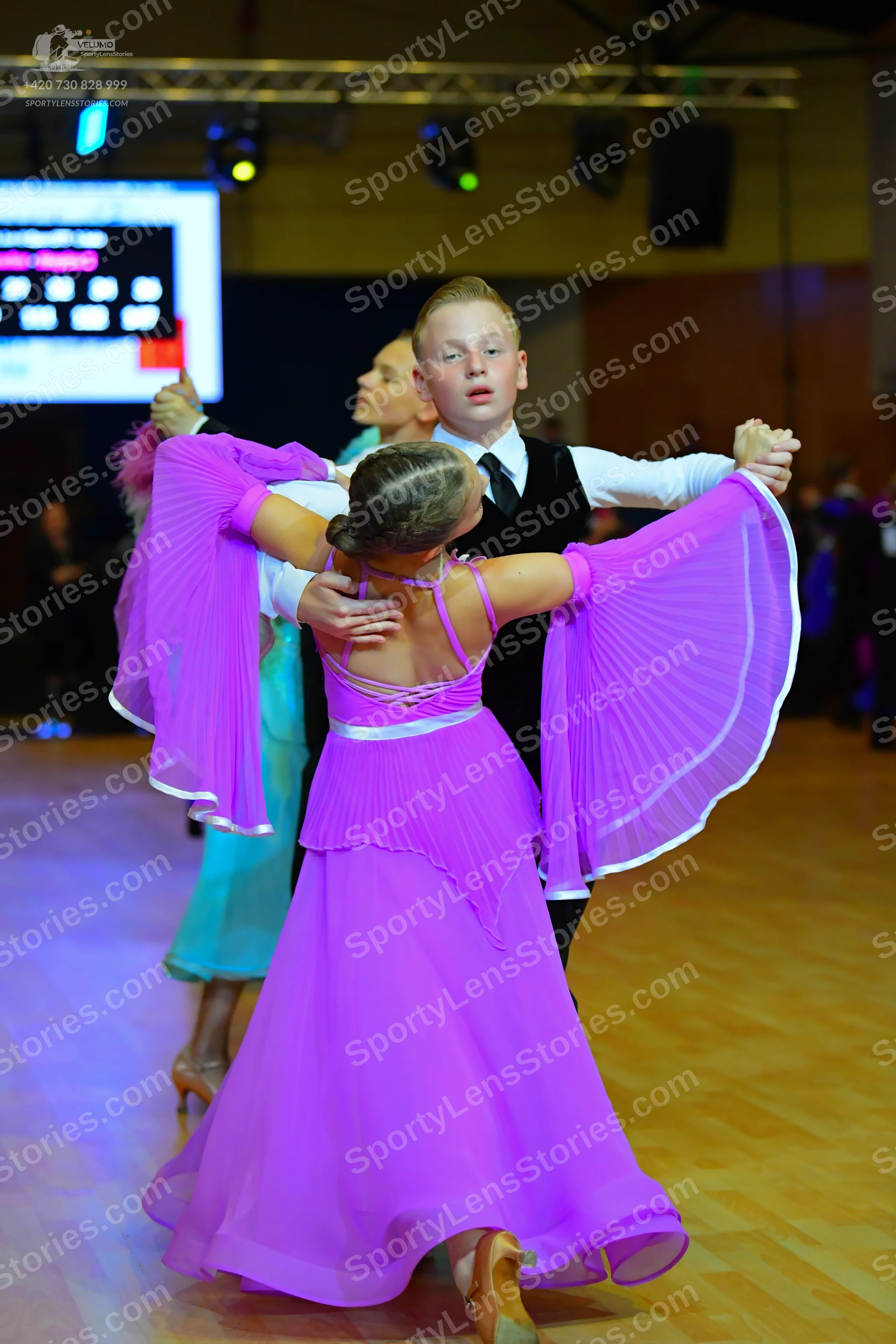 Dancesport competitor: Male dancer: white long-sleeved shirt, black waistcoat, black necktie, and black