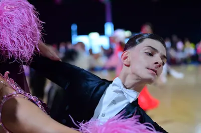 Dancesport competitor: Male dancer: black suit with white shirt and white bowtie