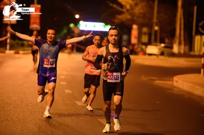Marathon runner #42215, #42252: Runner 1: blue jersey, blue shorts, white socks, white shoes