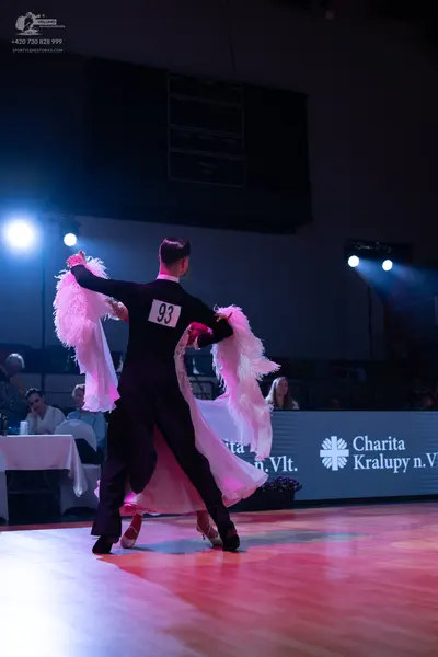 Dancesport competitor: Male dancer: black long-sleeved ballroom suit