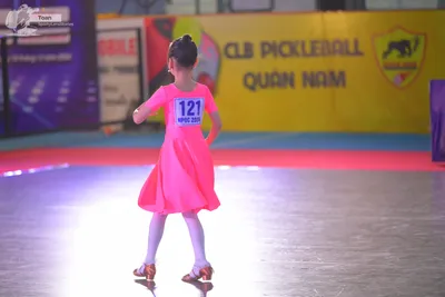 Dancesport competitor #121: ** Red Latin Dress
*   **Color:** Primarily Red
*   **Fabric:** Likely Satin (ap