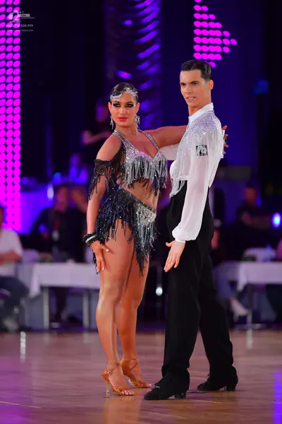 Dancesport competitor: Male dancer: white long-sleeved shirt and black trousers