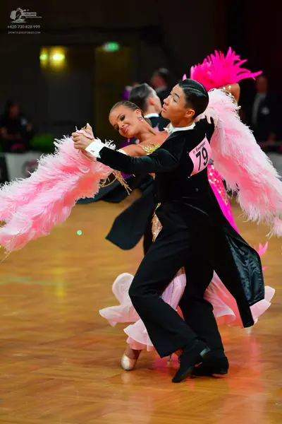 Dancesport competitor: Male dancer: black tailcoat with a white collar and black trousers