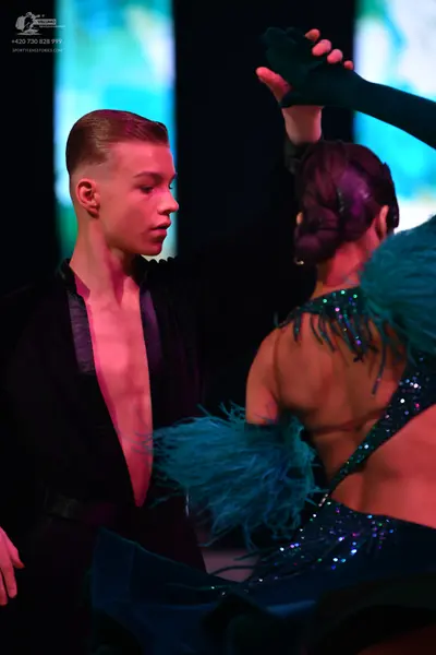 Dancesport competitor: Male dancer: black deep V-neck top