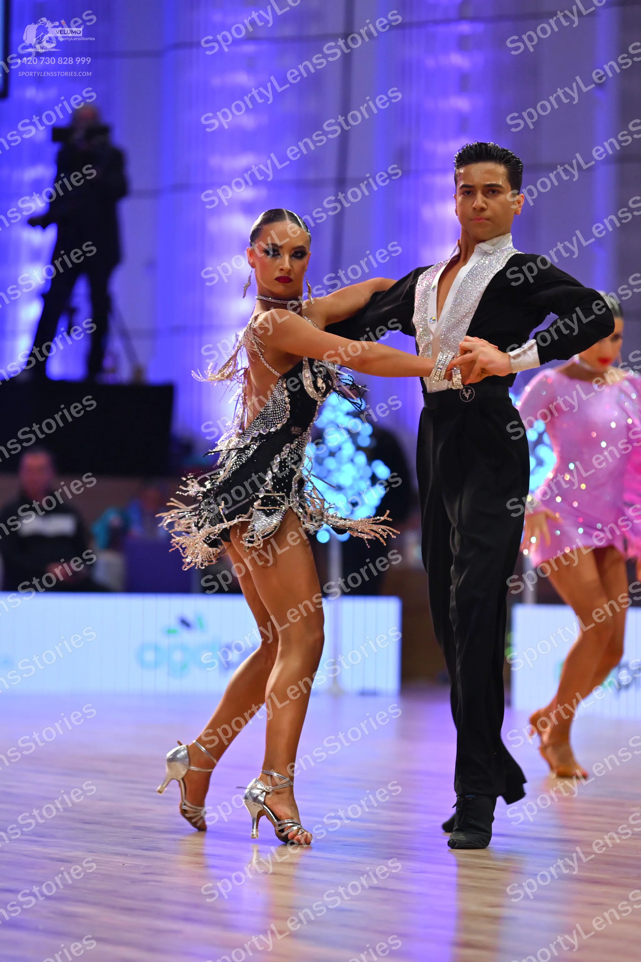 Dancesport competitor: Female dancer: black and silver latin dress with sequins and fringe-like details