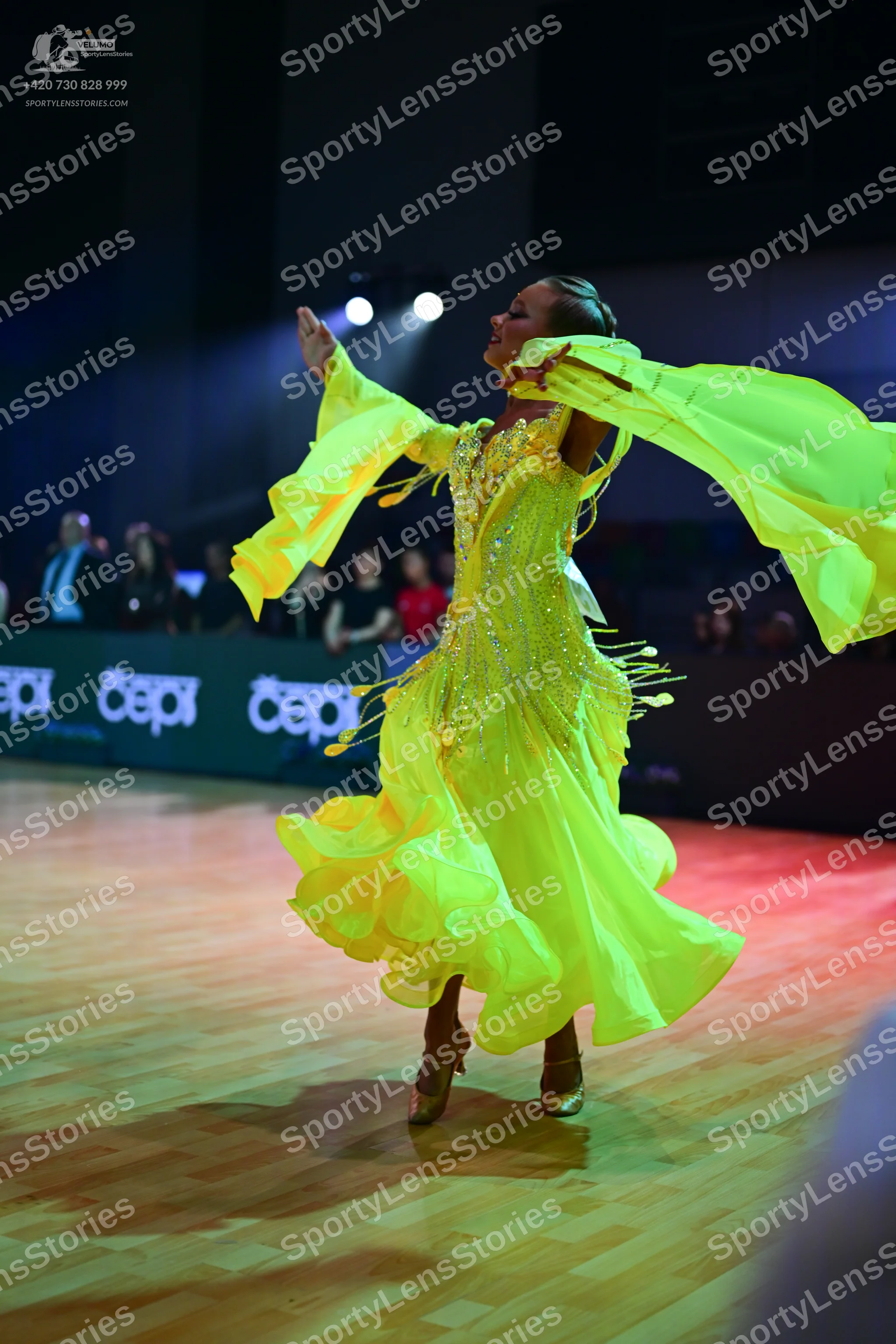 Dancesport competitor: Female dancer: bright yellow latin dance dress with a sequined bodice and a flow