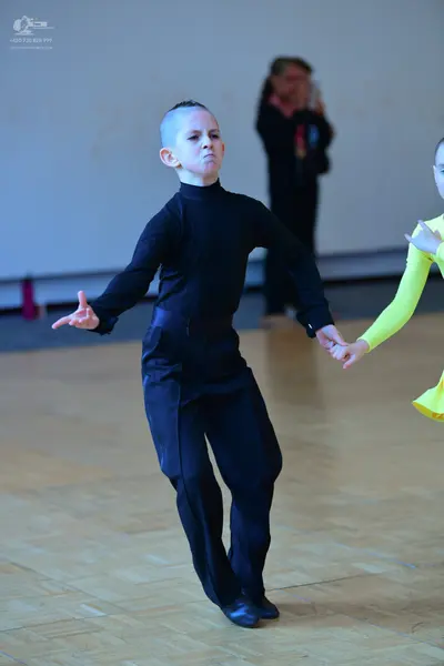 Dancesport competitor: Male dancer: black long-sleeved high-neck top and black trousers
