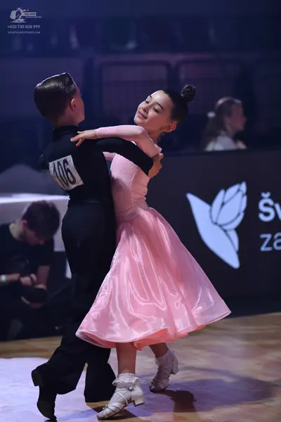 Dancesport competitor: Male dancer: black long-sleeved shirt and black trousers