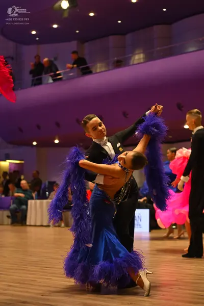 Dancesport competitor: Male dancer: black suit with a white shirt