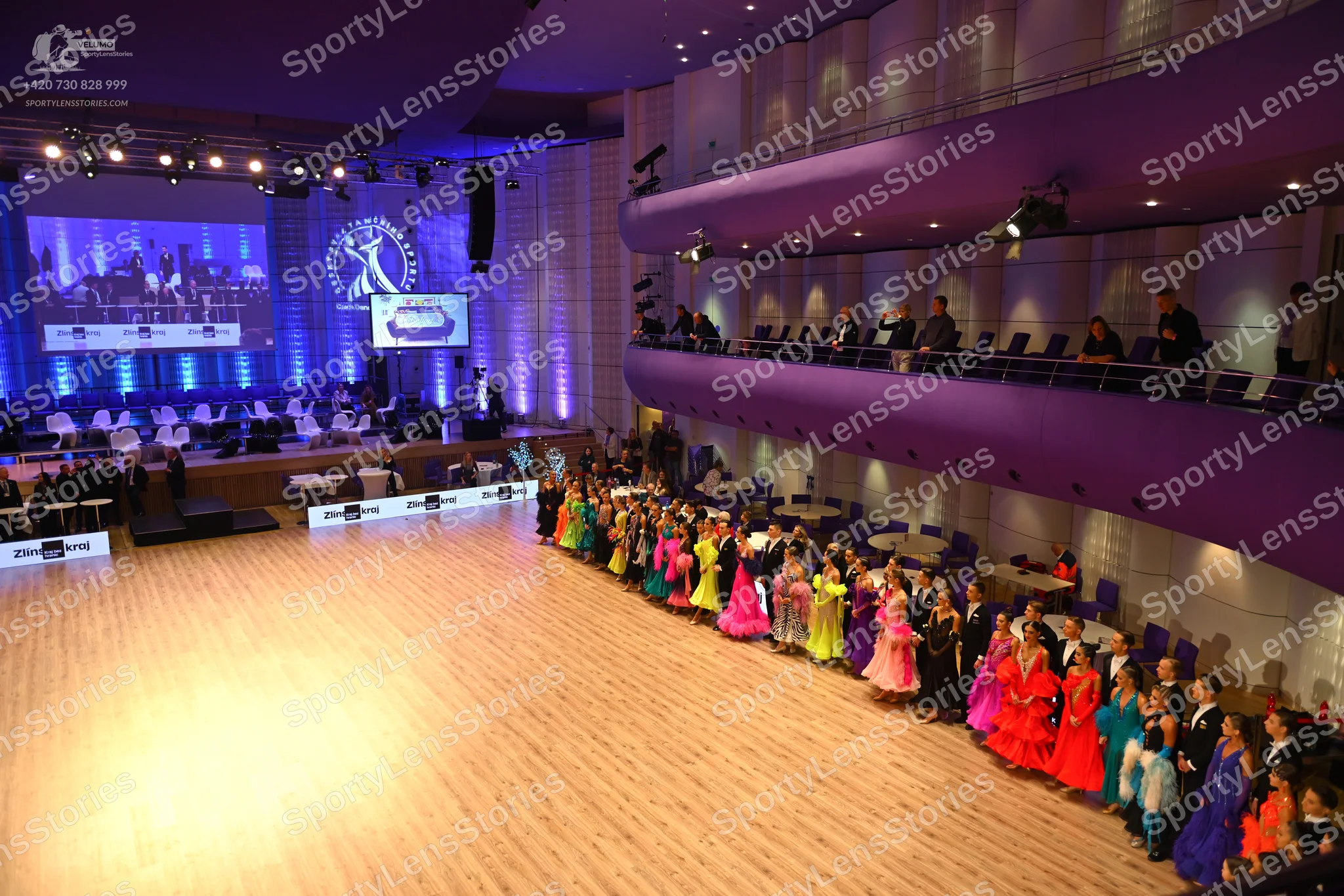 Dancesport competitor: Female dancers: A variety of brightly colored Latin dresses in shades of green,