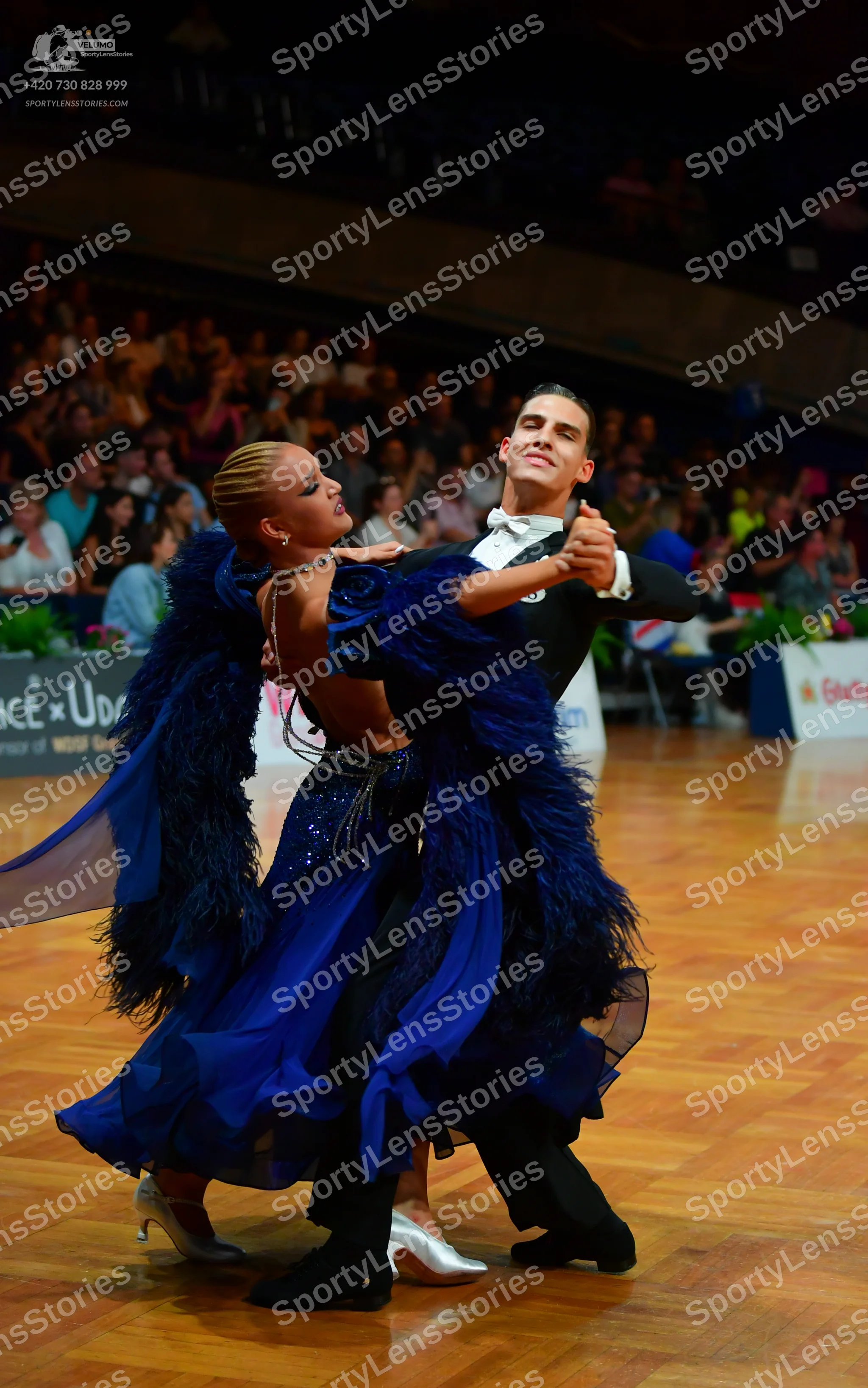 Dancesport competitor: Female dancer: royal blue ballroom dress with a sequined bodice and a voluminous