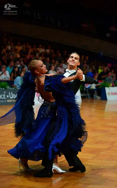 Dancesport competitor: Female dancer: royal blue ballroom dress with a sequined bodice and a voluminous