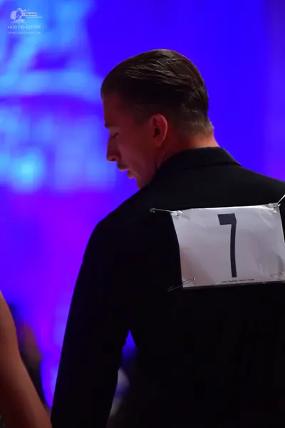 Dancesport competitor: Male dancer: black suit jacket