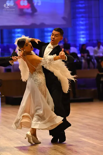 Dancesport competitor: Male dancer: black suit with a white shirt and white bow tie