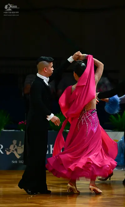 Dancesport competitor: Male dancer: black suit with a white shirt