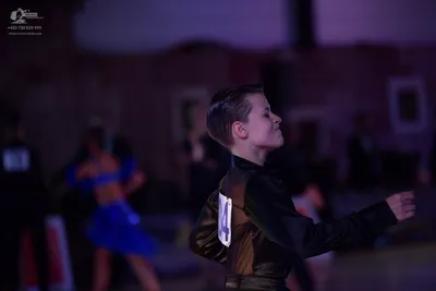 Dancesport competitor: Male dancer: dark, satin-finish long-sleeved dance top
