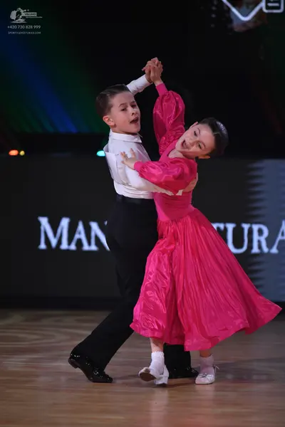Dancesport competitor: Male dancer: white long-sleeved shirt and black trousers