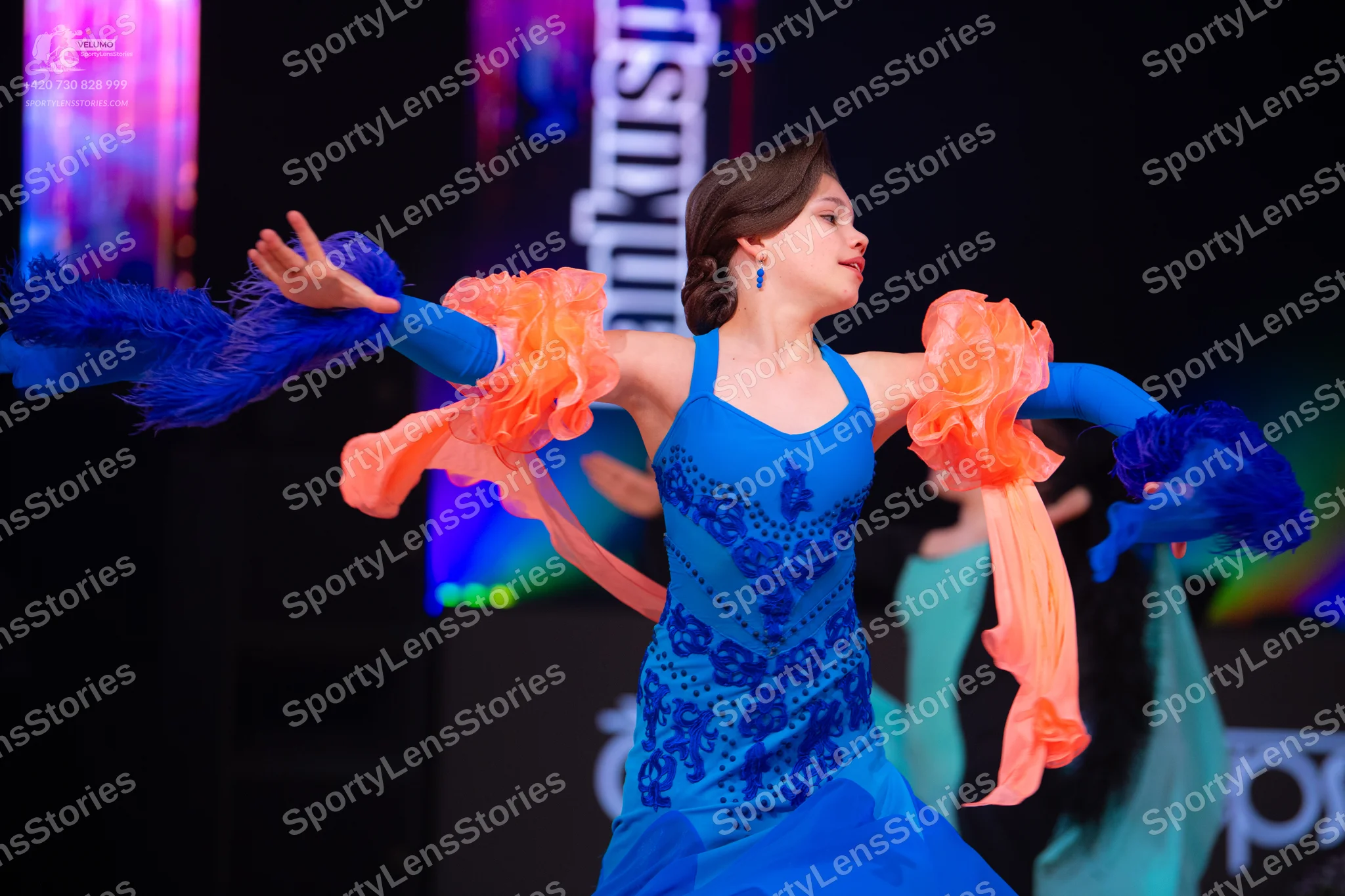 Dancesport competitor: Female dancer: blue latin dress with dark blue sequin patterns on the bodice, fe