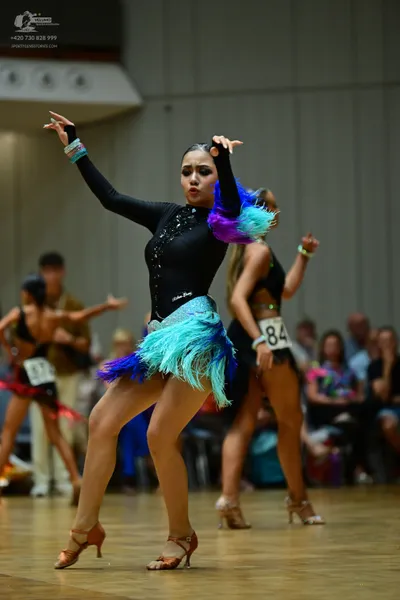 Dancesport competitor #84: Black, sequined long-sleeved leotard with a shimmering, heavily fringed skirt in