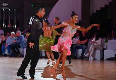 Dancesport competitor: Male dancer: black long-sleeved shirt with sequins on the sleeve and black trous