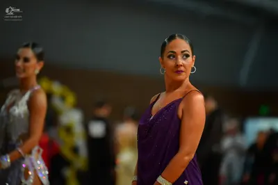 Dancesport competitor: Female dancer (left): silver latin dress with sequin embellishments