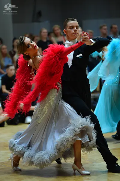 Dancesport competitor: Male dancer: black suit with a white shirt, white bowtie, and a white pocket squ