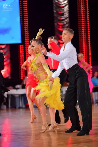 Dancesport competitor: Male dancer: white long-sleeved shirt and black trousers