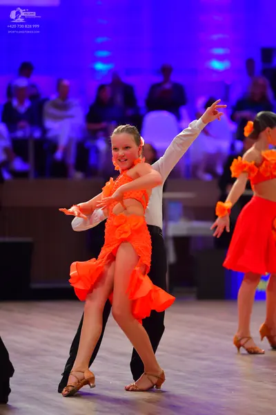 Dancesport competitor: Male dancer: white long-sleeved shirt and black trousers
