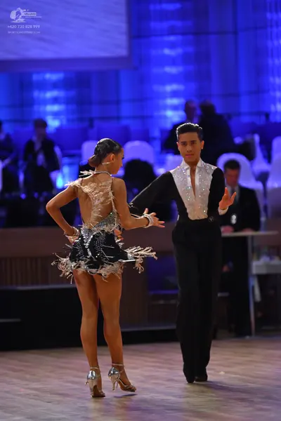 Dancesport competitor: Female dancer: black latin dress with silver sequins and fringe