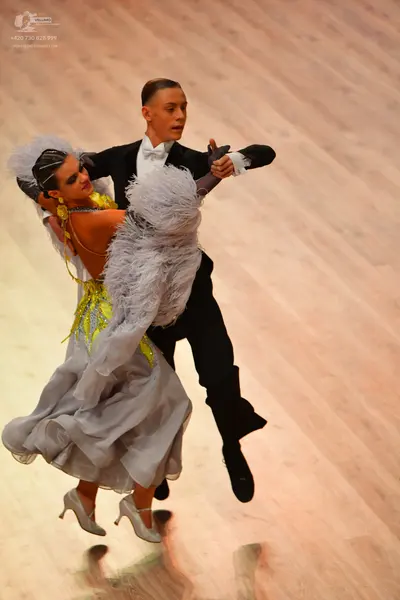 Dancesport competitor: Male dancer: black suit with a white shirt and white bow tie